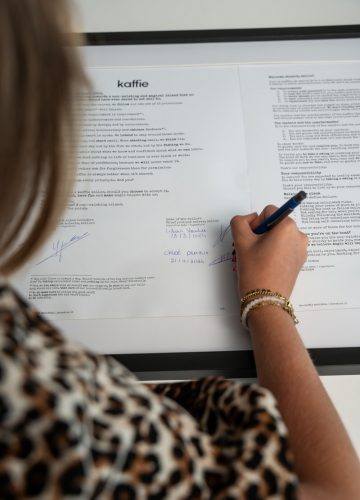A woman writing on a piece of paper