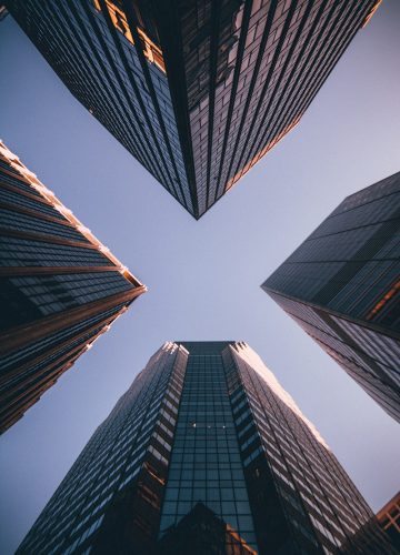 low-angle photography of four high-rise buildings